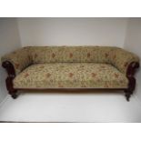 A Victorian mahogany framed three seater settee, floral tapestry upholstery, carved scroll arms,