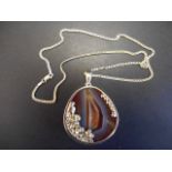 A handcrafted silver mounted druse agate pendant on silver necklace chain