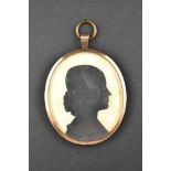 A Victorian double sided silhouette in yellow meal pendant frame - H8cm. CONDITION REPORT: