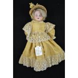 An Armand Marseille doll, bisque headed doll with sleepy brown eyes, open mouth with teeth,