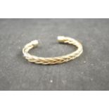 A 9ct gold torque bangle of plaited form - approx weight 45.8g CONDITION REPORT: good condition