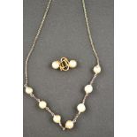 A pair of 14kt gold screw-on earrings set with pearls, together with a silver necklace mounted