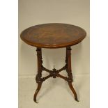 A mid Victorian inlaid walnut occasional table supported on four legs with cross stretcher and white