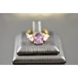 A 9ct gold three stone amethyst ring - size M 1/2. CONDITION REPORT: Good condition.