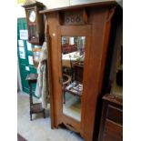 Oak Arts & Crafts Single wardrobe with carved detail and bevel edge mirror