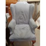 Upholstered Wing back elbow chair on walnut pad feet