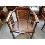 1920s Oak elbow chair with caned seat and back over bobbin turning