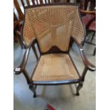 1930s Cane back elbow chair on splayed legs