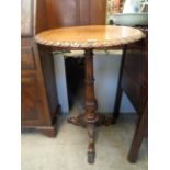 Good quality 19thC Walnut wine table with carved moulding above column carved supported on paw feet