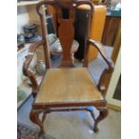 Walnut framed elbow chair with shaped back and upholstered seat