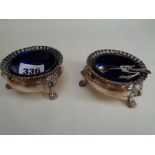 Pr. Of Good Quality Late 19thC Silver on Copper Salts with blue glass liners supported on Lions head