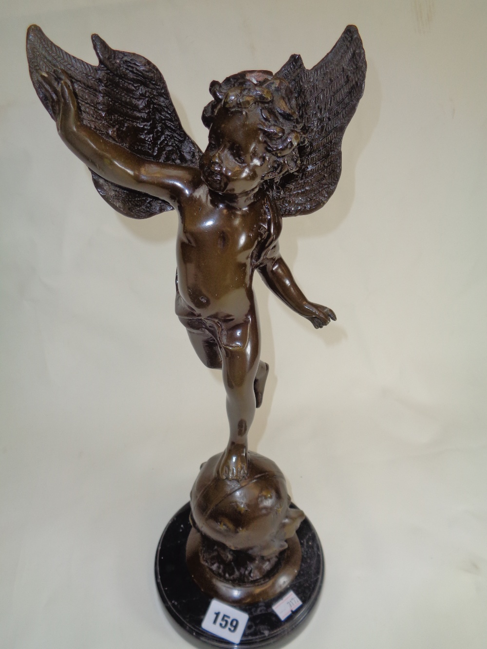 Unsigned Bronze of winged cherub on Globe with star decoration and marble base