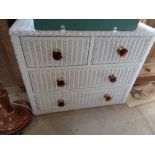 Cane white painted chest of drawers with amber glass handles