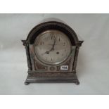 19thC Silver on copper mantel clock with arched top above Corinthian columns, French gong striking