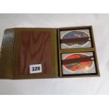 Leatherette cantilever card case with unused cards and accessories