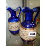 Pr. Of Royal Doulton blue glazed ewers with incised gilt decoration