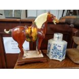 Chinese Pottery Tang type horse on wooden plinth and a Blue & White Pottery prunus decorated tea