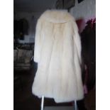 A white Fox fur coat full length.