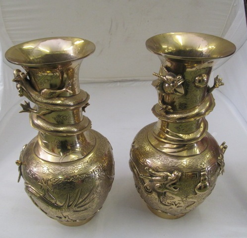 A pair of oriental brass vases.