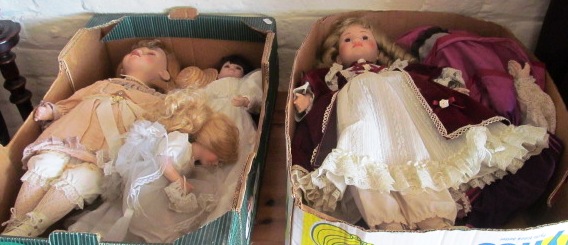 Four porcelain headed dolls and a large rag doll