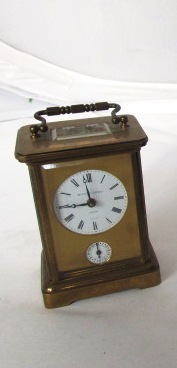 A 19th century brass Carriage clock with circular enamel dial and alarm dial
