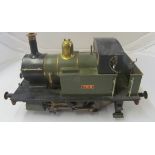 A model steam engine with shovel and poker (on coal) 'The Titch'