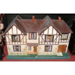 A large double fronted TRI-ANG Stockbroker dolls house in the Tudor style - circa 1930’s - with