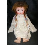 An old Armand Marseille bisque head doll with composite body, rolling eyes and open mouth with