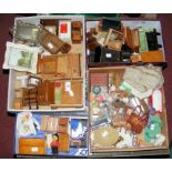 Four boxes of vintage and other dolls house furniture, including chests of drawers, dressers,
