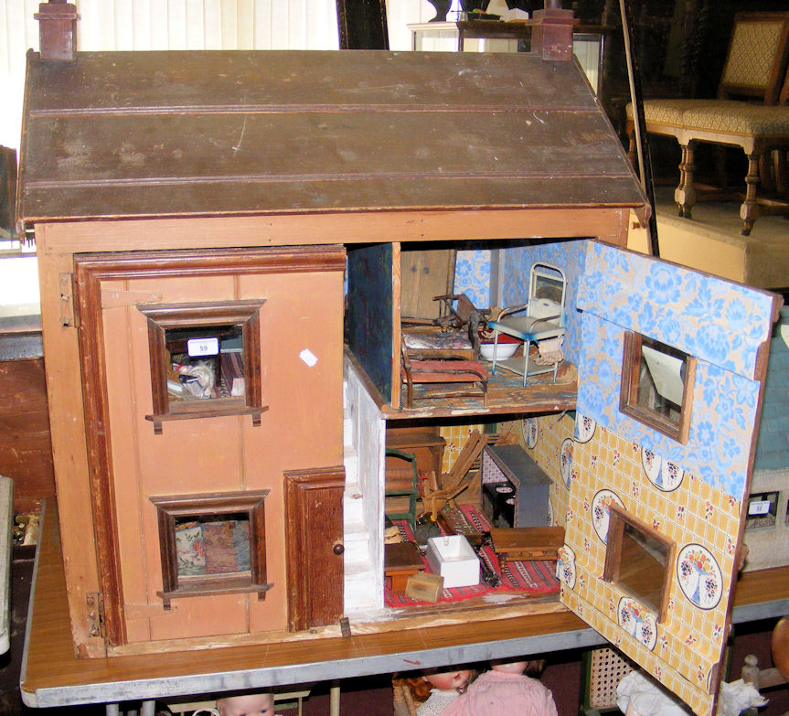 An old large wooden town dolls house with four rooms fitted with vintage furniture - 85cm wide x
