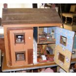 An old large wooden town dolls house with four rooms fitted with vintage furniture - 85cm wide x