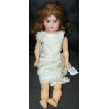 An old Armand Marseille bisque head doll with rolling eyes and open mouth, having composite body -