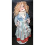 An old Armand Marseille bisque head doll with rolling glass eyes, open mouth and composite body -