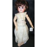 An old French bisque head doll with rolling eyes and open mouth, having composite body and impress