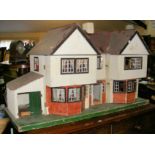 An old TRI-ANG 77 double fronted dolls house with five rooms fitted with vintage furniture - 110cm