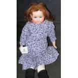 An old Ernest Heubach bisque head baby doll with rolling glass eyes and open mouth - impress mark
