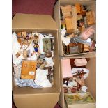 Three boxes containing various vintage and other dolls house furniture, including wardrobes, beds,