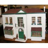 An antique 1920’s style dolls house with bay windows, four rooms fitted with vintage furniture,