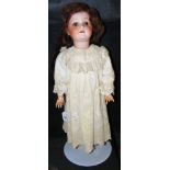 An old German bisque head doll with rolling eyes and open mouth - composite body - in original