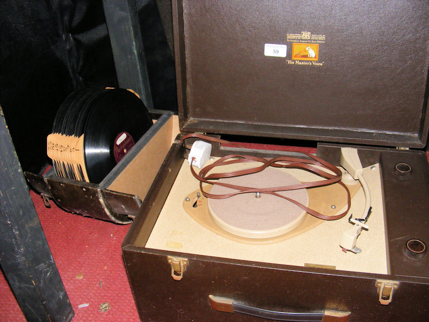 An electric HMV record player, together with a selection of records in carrying case