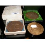 Bronze medallion in presentation case, together with two others