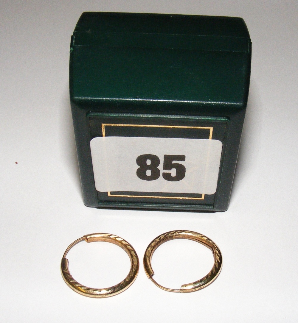 A pair of 9ct gold hoop ear rings.