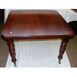 A Victorian dining table standing on fou