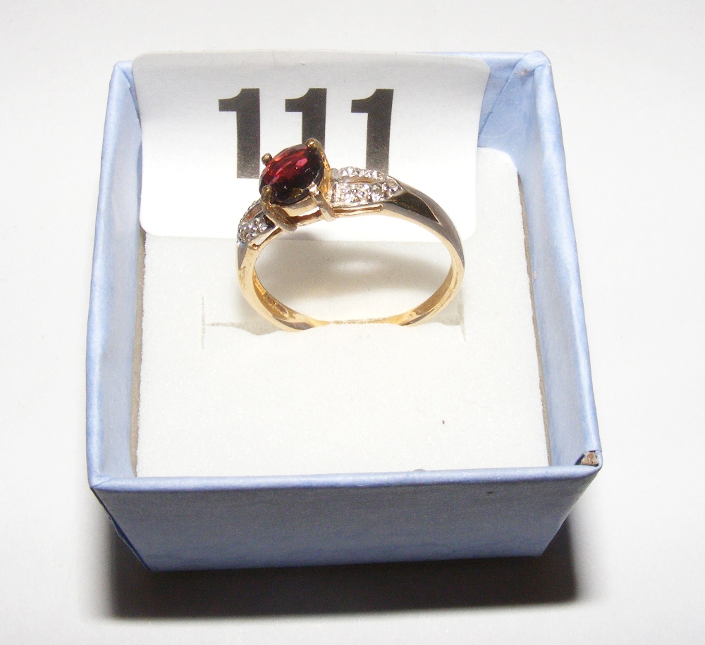 A gold ring set with garnet & diamond, r