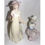 A Nao porcelain figurine of a girl holding a flower & another Nao figurine of a girl holding a