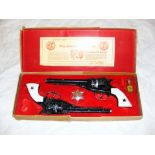 The Apache .44 Calibre Remington Toy Pistol Set, made by B.C.M. Company Derby Ltd, with gun oil &