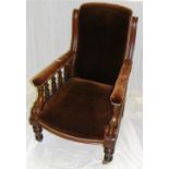 A Victorian armchair upholstered in brow