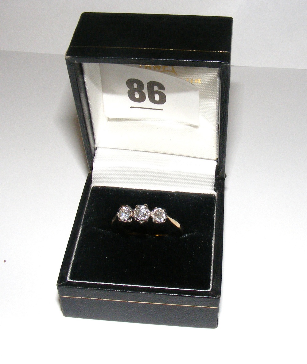 An 18ct gold ring set with three diamond
