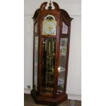 A large grandfather clock with glass she