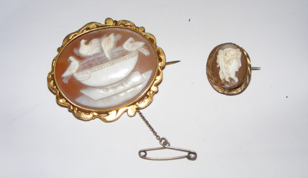 A signed cameo brooch in a yellow metal